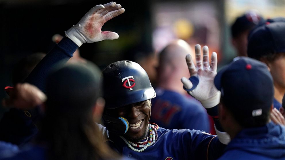 Minnesota Twins' Nick Gordon, middle, celebrates in the dugout after hitting a two-run home run against the Kansas City Royals during the second inning of a baseball game Thursday, Sept. 15, 2022, in Minneapolis. (AP Photo/Abbie Parr)