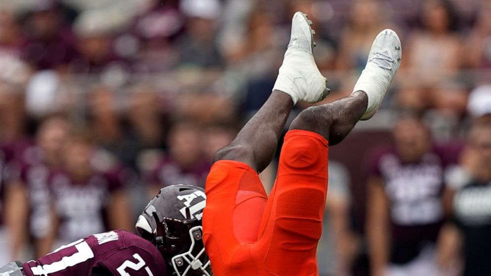 Sam Houston State wide receiver Ife Adeyi (2) flips upside down as Texas A&M defensive back Antonio Johnson (27) defends during the first half of an NCAA college football game Saturday, Sept. 3, 2022, in College Station, Texas. (AP Photo/David J. Phillip)