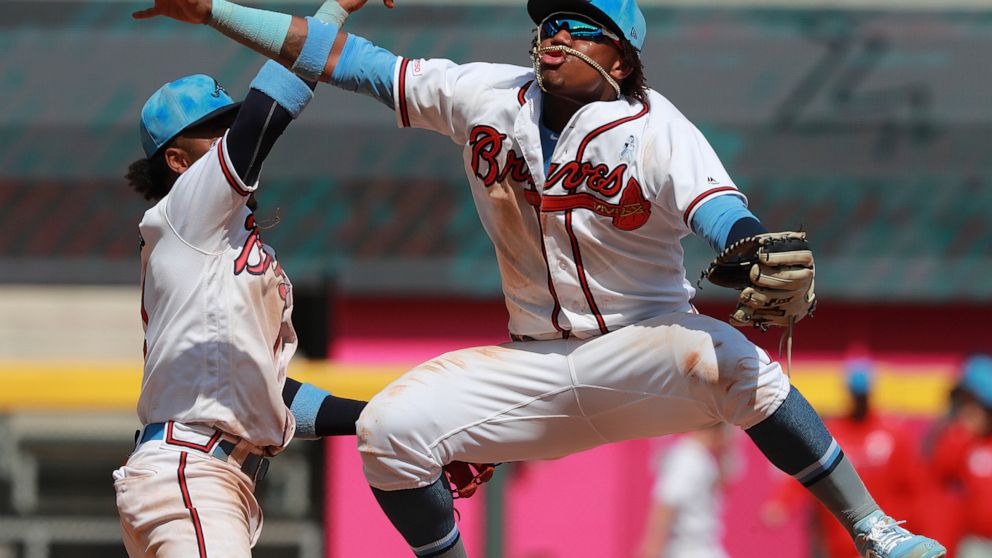 Atlanta Braves' Ronald Acuna Jr., right, and Ozzie Albies celebrate a victory over the Philadelphia Phillies in a baseball game Sunday, June 16, 2019, in Atlanta. (Curtis Compton/Atlanta Journal-Constitution via AP)