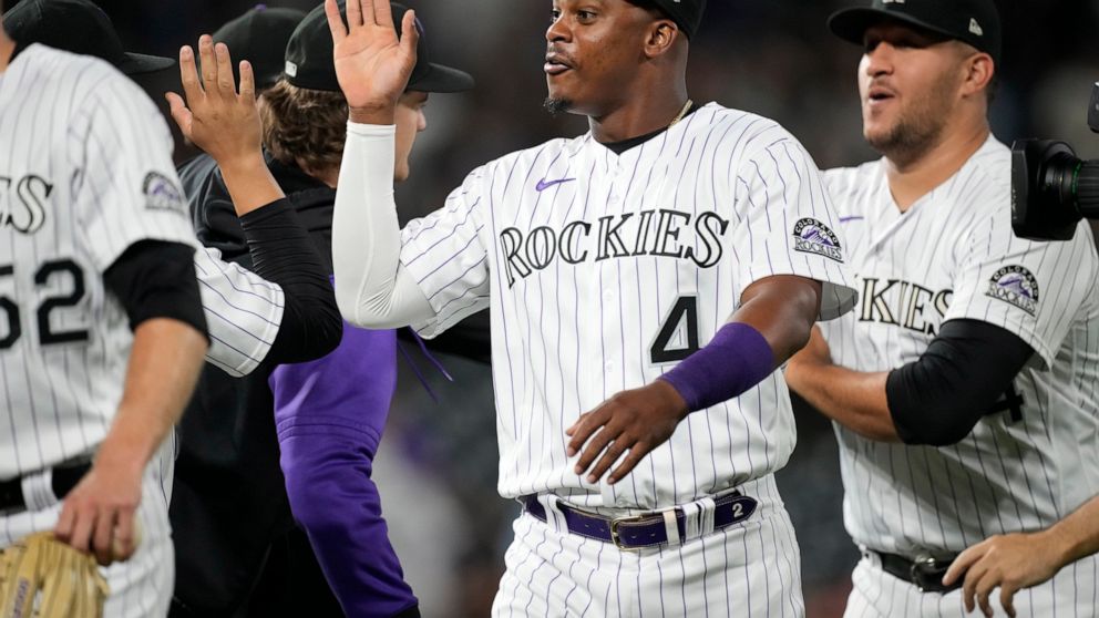Colorado Rockies' Elehuris Montero is congratulated by teammates after the team's baseball game against the San Francisco Giants on Friday, Aug.19, 2022, in Denver. Montero hit two home runs in the game. (AP Photo/David Zalubowski)