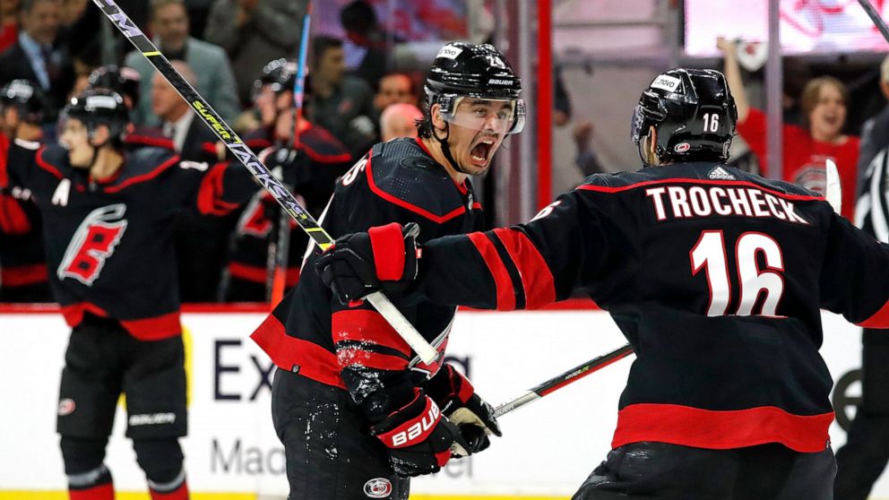 Carolina Hurricanes' Seth Jarvis, center, celebrates his goal with teammate Vincent Trocheck (16) during the second period of Game 5 of an NHL hockey Stanley Cup first-round playoff series against the Boston Bruins in Raleigh, N.C., Tuesday, May 10, 
