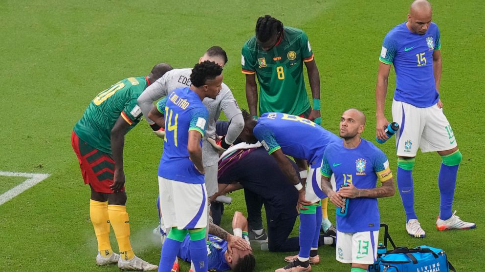 Brazil's Alex Telles is injured during the World Cup group G soccer match between Cameroon and Brazil, at the Lusail Stadium in Lusail, Qatar, Friday, Dec. 2, 2022. (AP Photo/Alessandra Tarantino)
