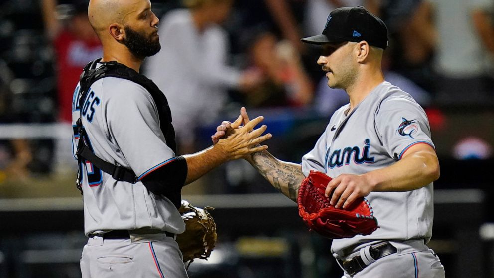 Miami Marlins relief pitcher Tanner Scott, right, celebrates with catcher Jacob Stallings, left, after a baseball game against the New York Mets, Friday, July 8, 2022, in New York. (AP Photo/Frank Franklin II)