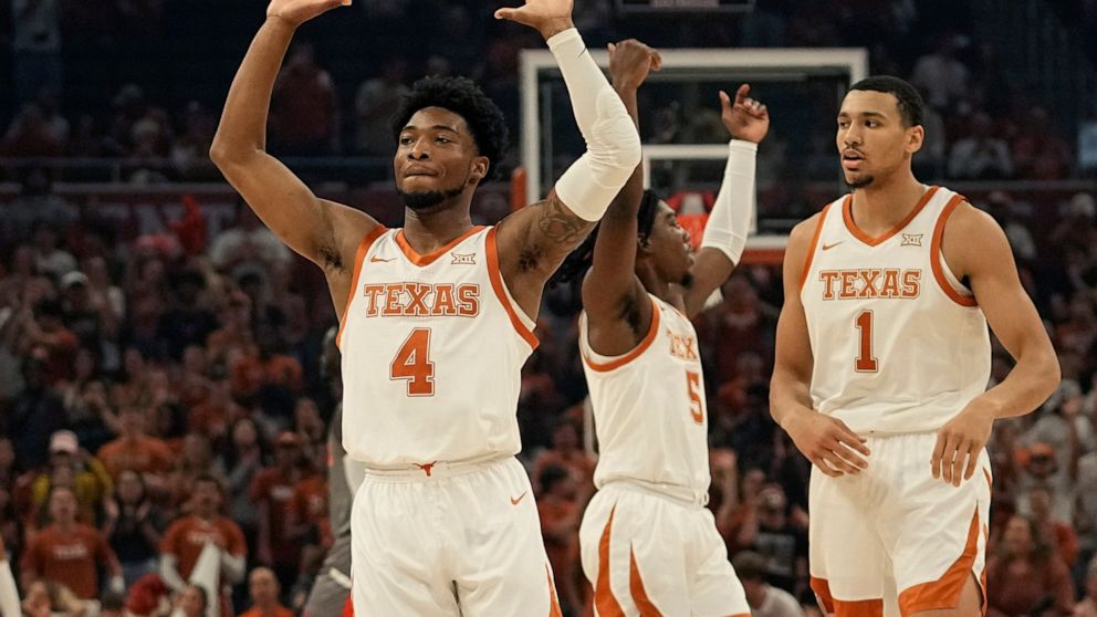 Texas guard Arterio Morris (2) celebrates a score with teammates Marcus Carr (5) and Dylan Disu (1) during the first half of an NCAA college basketball game against Houston Christian, Thursday, Nov. 10, 2022, in Austin, Texas. (AP Photo/Eric Gay)