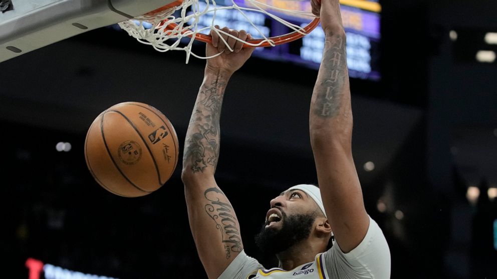 Los Angeles Lakers' Anthony Davis dunks during the second half of an NBA basketball game against the Milwaukee Bucks Friday, Dec. 2, 2022, in Milwaukee. (AP Photo/Morry Gash)