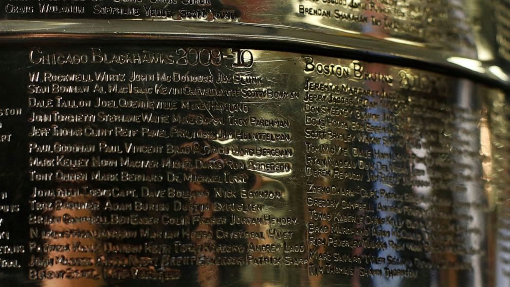 FILE - The names of the 2010 Stanley Cup Champion Chicago Blackhawks, left, are displayed on the Stanley Cup in the lobby of the United Center during an NHL hockey news conference on June 11, 2013 in Chicago. The first game of the Stanley Cup final s