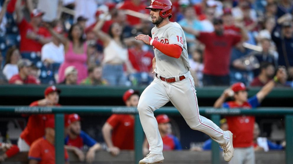 Philadelphia Phillies' Matt Vierling runs toward home to score on a single by Rhys Hoskins during the 10th inning of the team's baseball game against the Washington Nationals, Saturday, June 18, 2022, in Washington. The Phillies won 2-1 in 10 innings