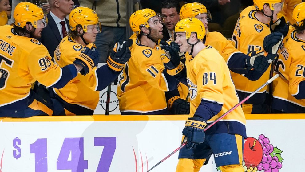 Nashville Predators' Tanner Jeannot (84) is congratulated after scoring a goal against the Toronto Maple Leafs in the first period of an NHL hockey game Saturday, March 19, 2022, in Nashville, Tenn. (AP Photo/Mark Humphrey)