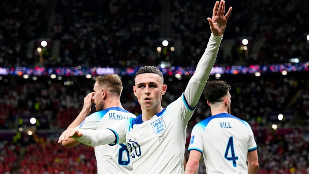 England's Phil Foden waves towards the fans after scoring his side's second goal during the World Cup group B soccer match between England and Wales, at the Ahmad Bin Ali Stadium in Al Rayyan, Qatar, Tuesday, Nov. 29, 2022. (AP Photo/Pavel Golovkin)