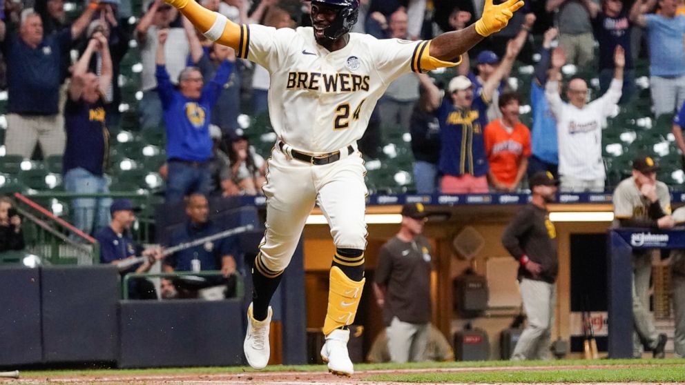 Milwaukee Brewers' Andrew McCutchen celebrates after hitting a walk-off RBI single during the ninth inning of a baseball game against the San Diego Padres Thursday, June 2, 2022, in Milwaukee. The Brewers won 5-4. (AP Photo/Morry Gash)