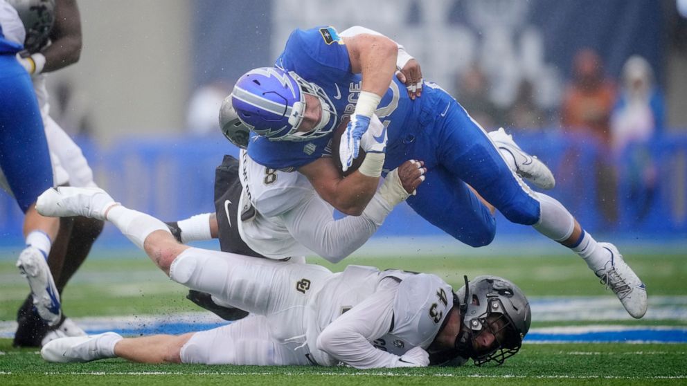 Air Force running back Brad Roberts, top right, is stopped after a short gain by Colorado linebacker Josh Chandler-Semedo and safety Trevor Woods in the first half of an NCAA college football game Saturday, Sept. 10, 2022, at Air Force Academy, Colo.