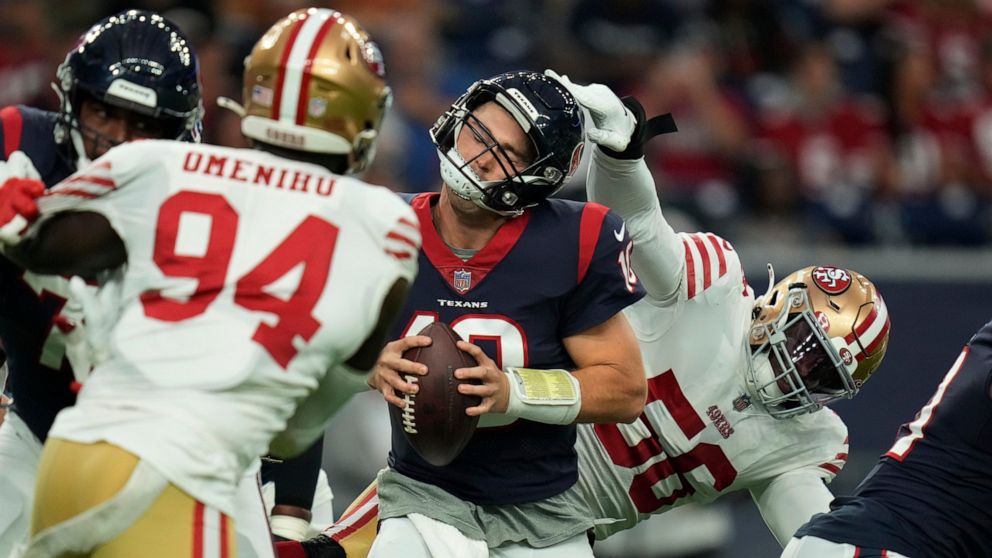 Houston Texans quarterback Davis Mills (10) is pressured by San Francisco 49ers defensive end Samson Ebukam (56) during the first half of an NFL football game Thursday, Aug. 25, 2022, in Houston. (AP Photo/Eric Christian Smith)