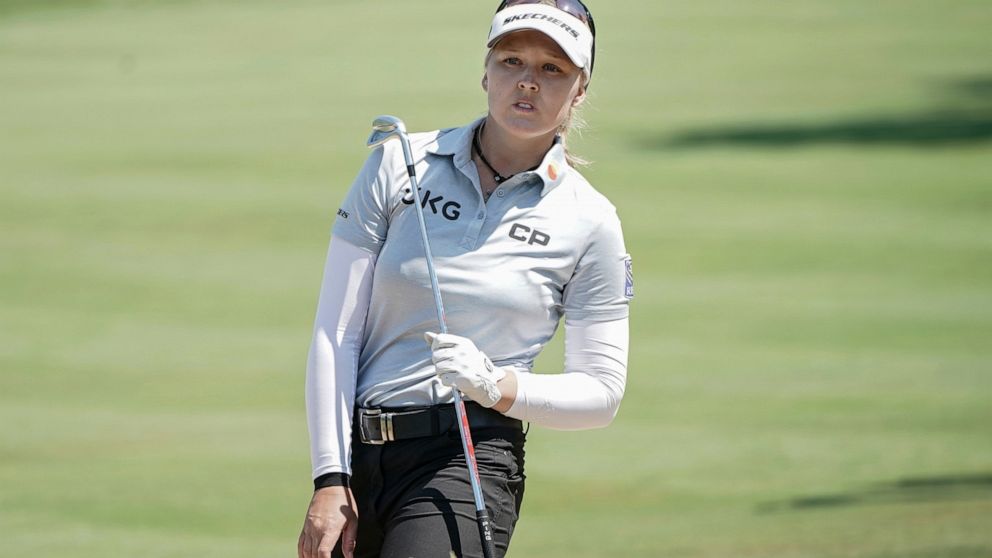 Brooke Henderson, of Canada, follows her ball after playing on the 5th hole during the last round of the Evian Championship women's golf tournament in Evian, eastern France, Sunday, July 24, 2022. (AP Photo/Laurent Cipriani)