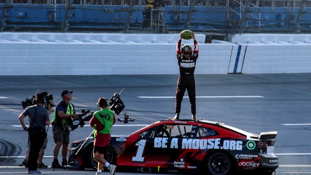 Ross Chastain, top, celebrates by slamming a watermelon to the ground after winning a NASCAR Cup Series auto race Sunday, April 24, 2022, in Talladega, Ala. (AP Photo/Skip Williams)