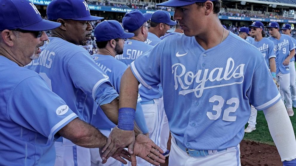 Kansas City Royals' Nick Pratto (32) celebrates with teammates after the first game of a baseball doubleheader against the Chicago White Sox Tuesday, Aug. 9, 2022, in Kansas City, Mo. The Royals won 4-2. (AP Photo/Charlie Riedel)
