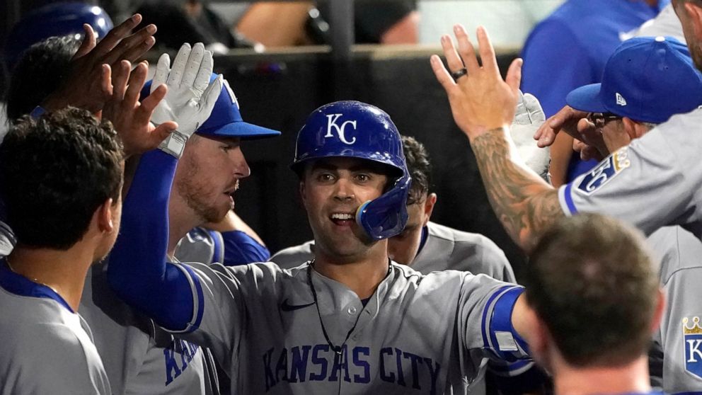 Kansas City Royals' Whit Merrifield celebrate in the dugout his home run off Chicago White Sox starting pitcher Michael Kopech during the sixth inning of a baseball game Monday, Aug. 1, 2022, in Chicago. (AP Photo/Charles Rex Arbogast)