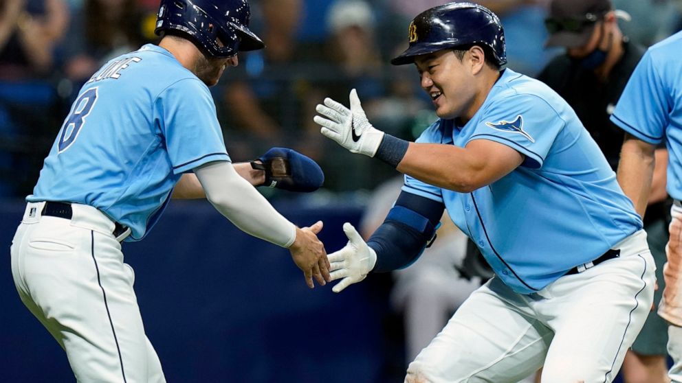 Tampa Bay Rays' Ji-Man Choi, right, celebrates his three-run home run off Oakland Athletics pitcher Adam Oller with Brandon Lowe during the second inning of a baseball game Tuesday, April 12, 2022, in St. Petersburg, Fla. (AP Photo/Chris O'Meara)