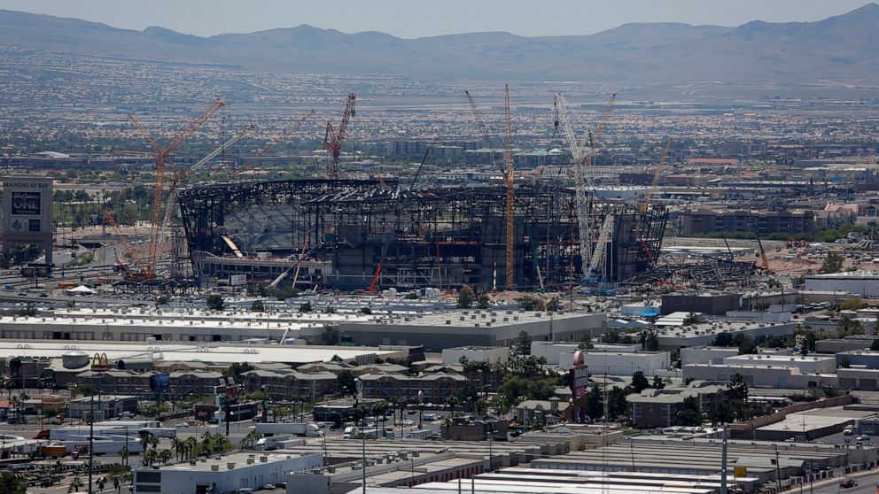Construction cranes surround the future NFL Raiders football stadium Tuesday, June 4, 2019, in Las Vegas. The Las Vegas Bowl is moving to the new stadium next year, and will feature teams from the SEC or Big Ten conferences against a Pac-12 contender