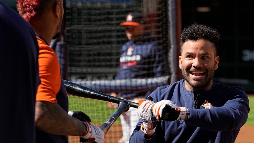 Houston Astros second baseman Jose Altuve, right, jokes with catcher Martin Maldonado during a practice ahead of Game 1 of baseball's American League Championship Series, in Houston, Tuesday, Oct. 18, 2022. (AP Photo/Eric Gay)