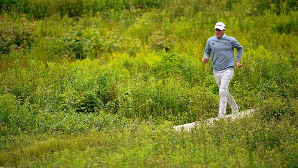 Joel Dahmen jogs to the 12th hole during the third round of the U.S. Open golf tournament at The Country Club, Saturday, June 18, 2022, in Brookline, Mass. (AP Photo/Robert F. Bukaty)