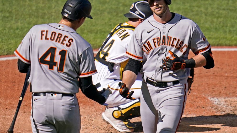 San Francisco Giants' Austin Slater, right, celebrates with Wilmer Flores (41) after hitting a solo home run off Pittsburgh Pirates starting pitcher Jose Quintana during the fifth inning of a baseball game in Pittsburgh, Saturday, June 18, 2022. (AP 
