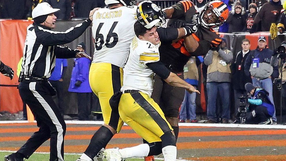 FILE - In this Nov. 14, 2019, file photo, Cleveland Browns defensive end Myles Garrett (95) hits Pittsburgh Steelers quarterback Mason Rudolph (2) with a helmet during the second half of an NFL football game in Cleveland. Suspended Browns star defens