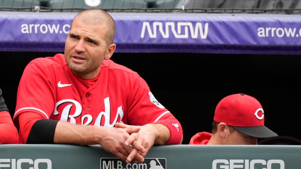 Cincinnati Reds' Joey Votto looks on from the dugout in the seventh inning of a baseball game against the Colorado Rockies, Sunday, May 1, 2022, in Denver. (AP Photo/David Zalubowski)