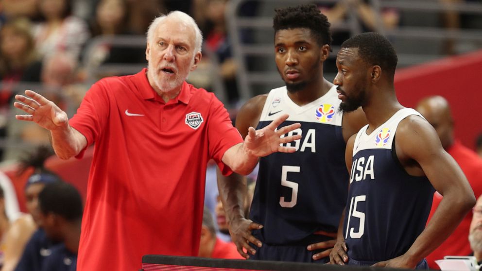 United States' coach Gregg Popovich, left talks to United States' Donovan Mitchell, center and United States' Kemba Walker at right for the FIBA Basketball World Cup in Dongguan in southern China's Guangdong province on Thursday, Sept. 12, 2019. The 