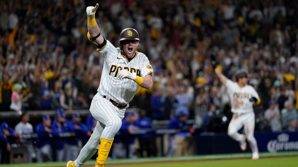 San Diego Padres' Jake Cronenworth reacts after hitting a two-run single during the seventh inning in Game 4 of a baseball NL Division Series against the Los Angeles Dodgers, Saturday, Oct. 15, 2022, in San Diego. (AP Photo/Ashley Landis)