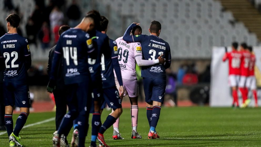 Belenenses' Joao Monteiro, center right, a goalkeeper who had to start as a field player, leaves the pitch with goalkeeper Alvaro Ramalho at the end of the Portuguese Primeira Liga soccer match between Belenenses SAD and SL Benfica, Saturday, Nov. 27