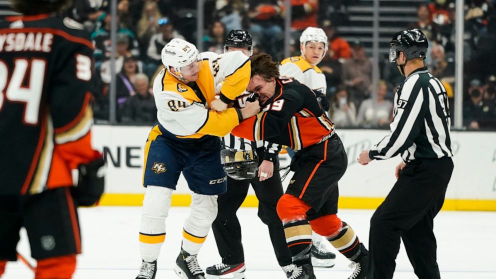 Nashville Predators' Tanner Jeannot, center left, fights with Anaheim Ducks' Sam Carrick during the first period of an NHL hockey game Monday, March 21, 2022, in Anaheim, Calif. (AP Photo/Jae C. Hong)
