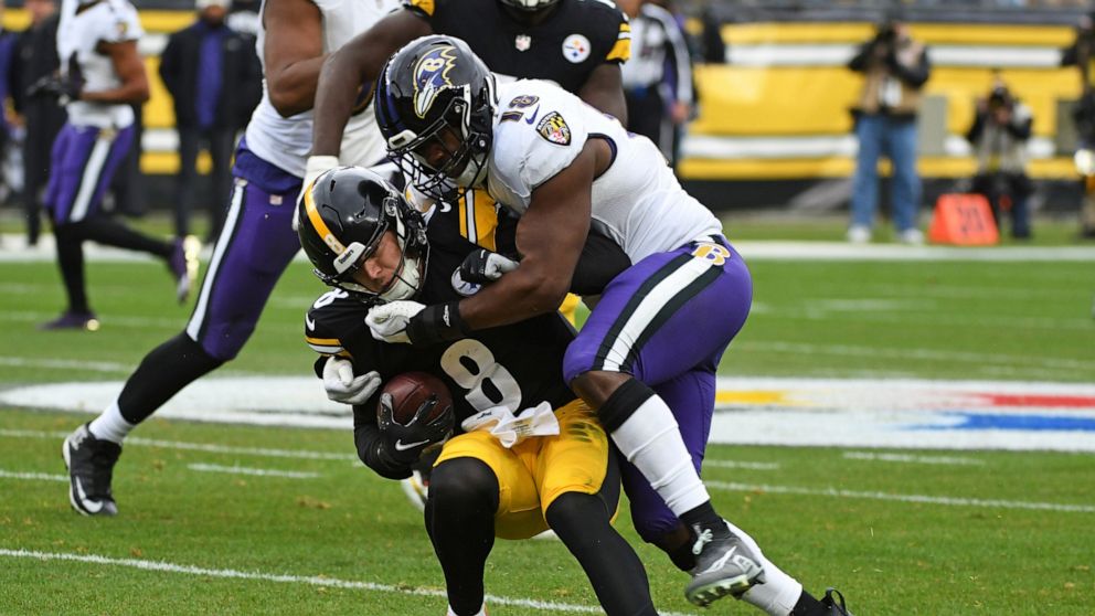 Pittsburgh Steelers quarterback Kenny Pickett (8) is tackled by Baltimore Ravens linebacker Roquan Smith (18) during the first half of an NFL football game in Pittsburgh, Sunday, Dec. 11, 2022. (AP Photo/Fred Vuich)