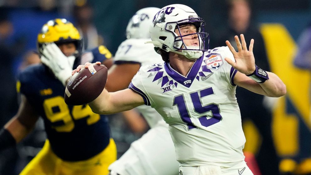 TCU quarterback Max Duggan (15) throws against Michigan during the first half of the Fiesta Bowl NCAA college football semifinal playoff game, Saturday, Dec. 31, 2022, in Glendale, Ariz. (AP Photo/Ross D. Franklin)