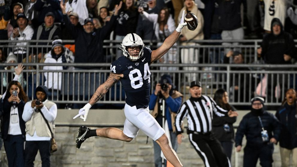 Penn State tight end Theo Johnson (84) scores a touchdown during the first half of an NCAA college football game against Michigan State, Saturday, Nov. 26, 2022, in State College, Pa. (AP Photo/Barry Reeger)