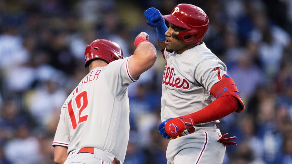 Philadelphia Phillies' Johan Camargo, right, and Kyle Schwarber celebrate Camargo's two-run home run against the Los Angeles Dodgers during the second inning of a baseball game in Los Angeles, Thursday, May 12, 2022. (AP Photo/Kyusung Gong)