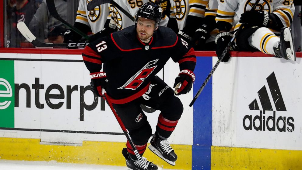 Carolina Hurricanes' Max Domi (13) moves the puck upice against the Boston Bruins during the second period of Game 7 of an NHL hockey Stanley Cup first-round playoff series in Raleigh, N.C., Saturday, May 14, 2022. (AP Photo/Karl B DeBlaker)