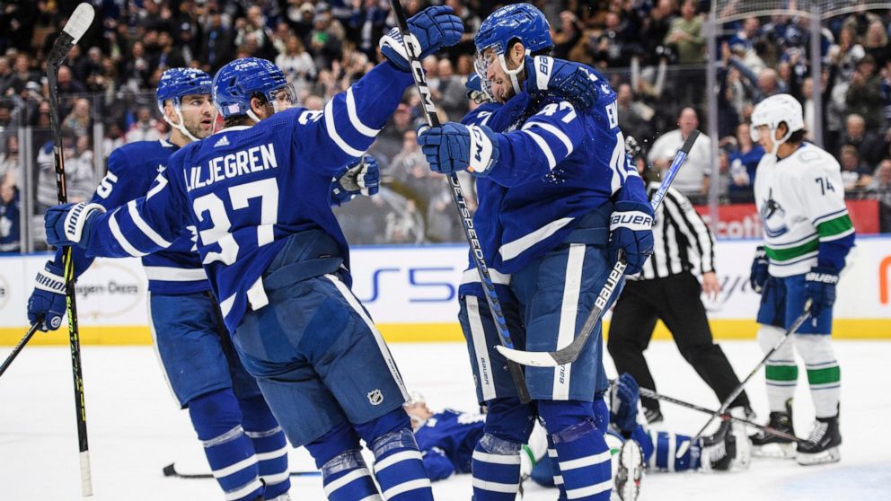 The Toronto Maple Leafs celebrate after left wing Pierre Engvall (47) scored against the Vancouver Canucks during the second period of an NHL hockey game in Toronto, Saturday, Nov. 12, 2022. (Christopher Katsarov/The Canadian Press via AP)