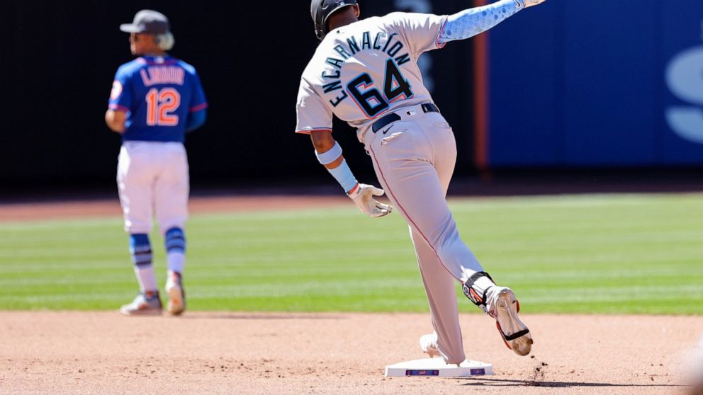 Miami Marlins' Jerar Encarnácion (64) reacts while rounding the bases after hitting a grand slam against New York Mets relief pitcher Seth Lugo during the seventh inning of a baseball game, Sunday, June 19, 2022, in New York. (AP Photo/Jessie Alcheh)