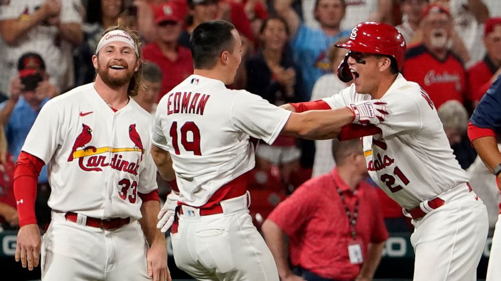 St. Louis Cardinals' Tommy Edman (19) is congratulated by teammates Brendan Donovan (33) and Lars Nootbaar (21) after hitting a two-run double to defeat the Washington Nationals 6-5 in a baseball game Wednesday, Sept. 7, 2022, in St. Louis. (AP Photo