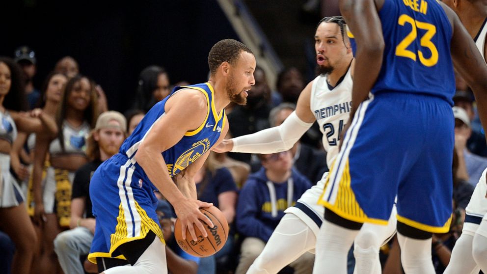 Golden State Warriors guard Stephen Curry, left, handles the ball against Memphis Grizzlies forward Dillon Brooks (24) in the first half during Game 1 of a second-round NBA basketball playoff series Sunday, May 1, 2022, in Memphis, Tenn. (AP Photo/Br