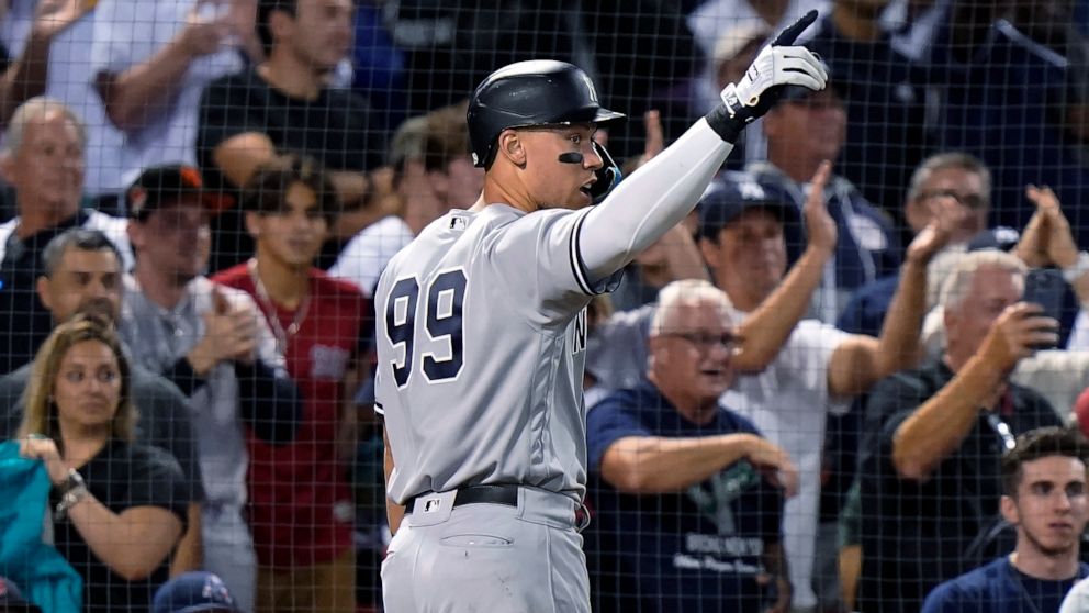 New York Yankees' Aaron Judge (99) celebrates after scoring on a three-run double by Gleyber Torres during the 10th inning of the team's baseball game against the Boston Red Sox, Tuesday, Sept. 13, 2022, in Boston. The Yankees won 7-6. (AP Photo/Stev