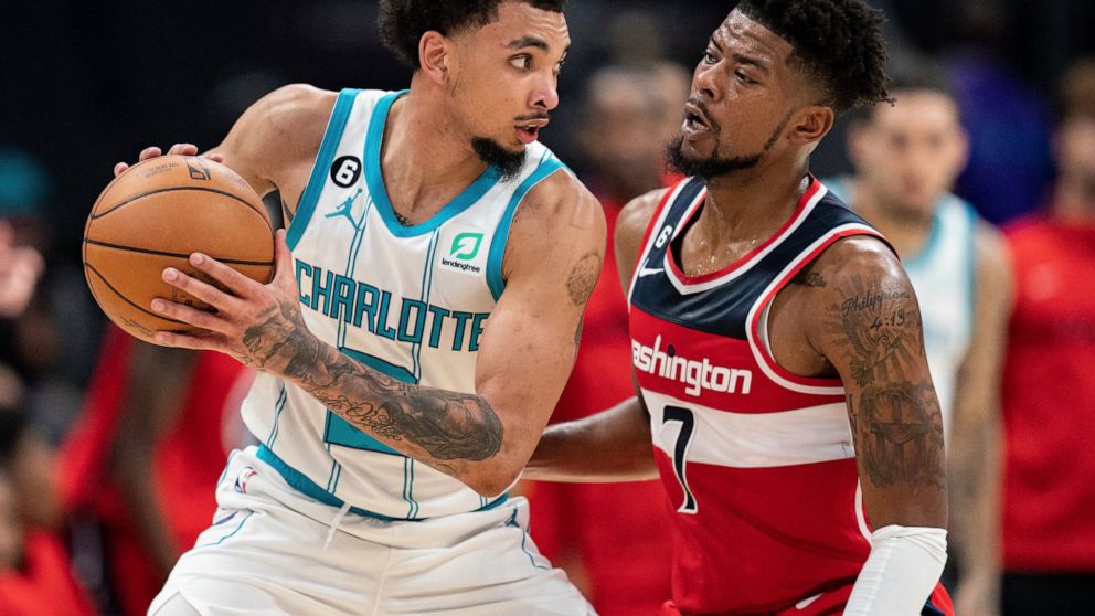 Washington Wizards guard Jordan Goodwin (7) guards Charlotte Hornets guard James Bouknight in the second half of an NBA preseason basketball game in Charlotte, N.C., Monday, Oct. 10, 2022. (AP Photo/Jacob Kupferman)