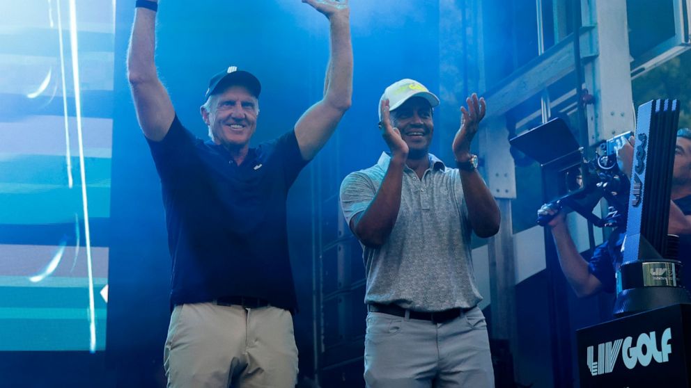 LIV Golf CEO Greg Norman, left, and LIV Golf managing director Majed Al Sorour cheer from the stage before the trophy presentation at the LIV Golf Invitational-Boston tournament, Sunday, Sept. 4, 2022, in Bolton, Mass. (AP Photo/Mary Schwalm)