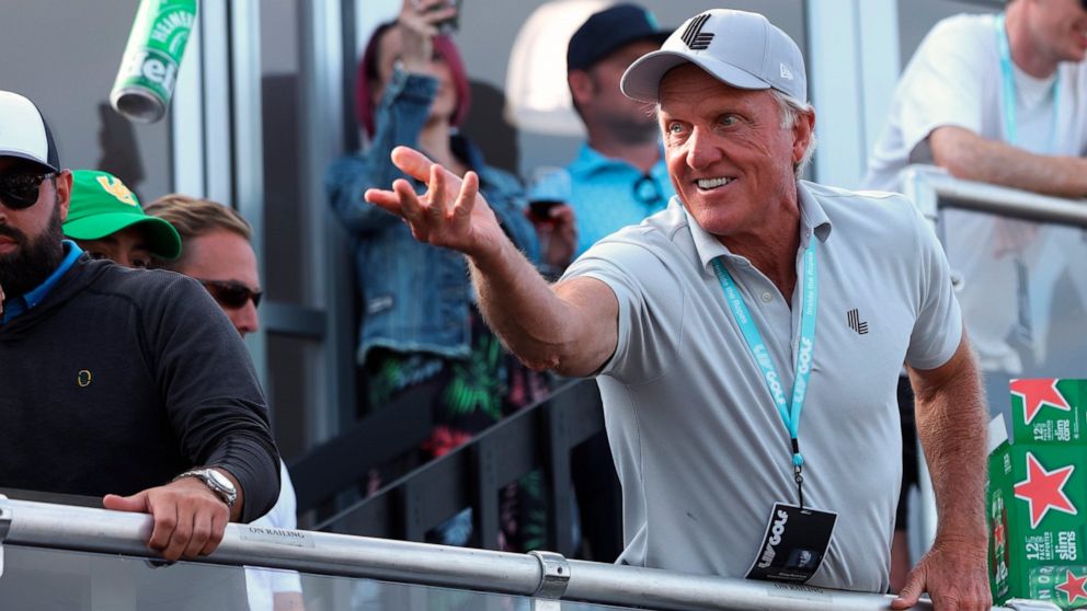 Greg Norman, CEO of LIV Golf, tosses a beer to spectators into the crowd surrounding the 18th green at the Portland Invitational LIV Golf tournament in North Plains, Ore., Saturday, July 2, 2022. (AP Photo/Steve Dipaola)