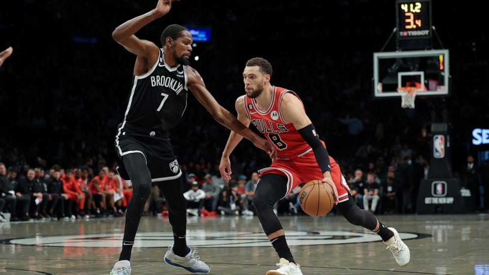 Chicago Bulls guard Zach LaVine (8) drives against Brooklyn Nets forward Kevin Durant (7) during the first half of an NBA basketball game Tuesday, Nov. 1, 2022, in New York. (AP Photo/Jessie Alcheh)