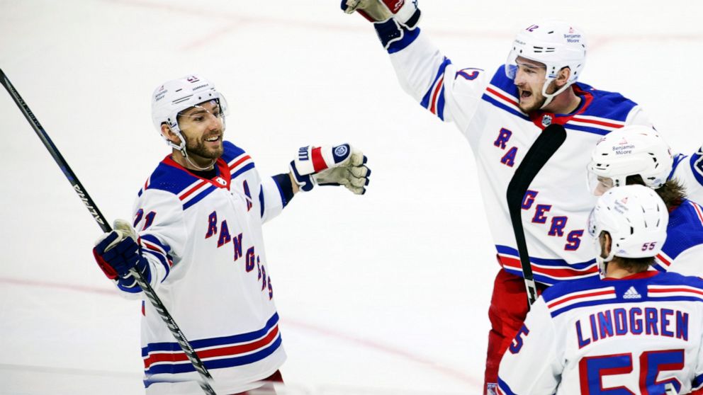 New York Rangers' Barclay Goodrow (21) celebrates his goal with teammates Julien Gauthier (12), Sammy Blais (91), and Ryan Lindgren (55) during the second period of an NHL hockey game against the Ottawa Senators, Wednesday, Nov. 30, 2022 in Ottawa, O