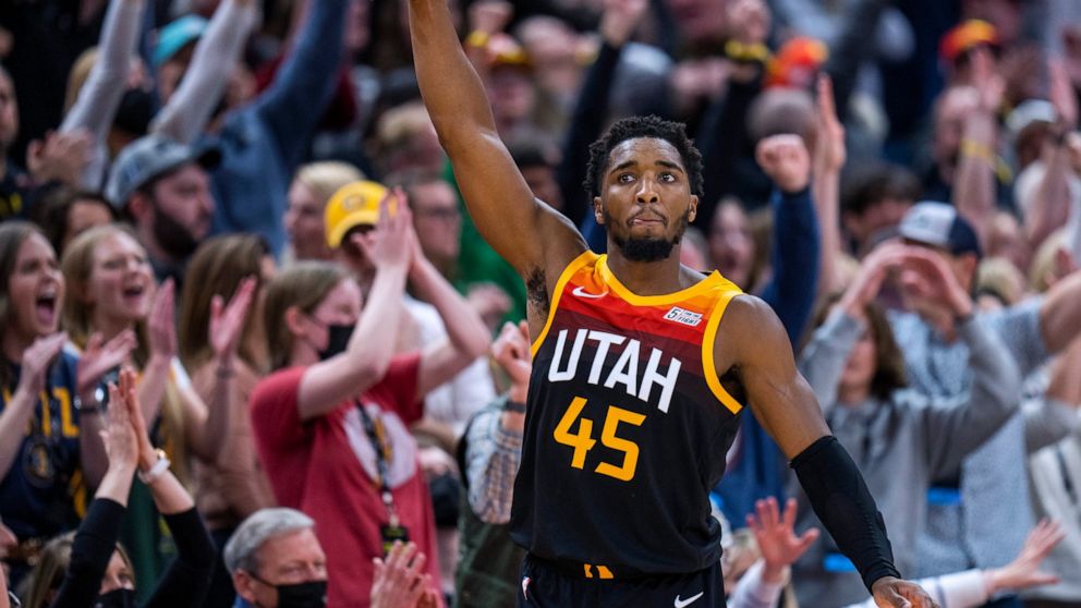 FILE - Utah Jazz guard Donovan Mitchell (45) reacts after hitting a 3-point shot against the Boston Celtics in the final minute of an NBA basketball game Friday, Dec. 3, 2021, in Salt Lake City. Cleveland made its acquisition of All-Star guard Donova