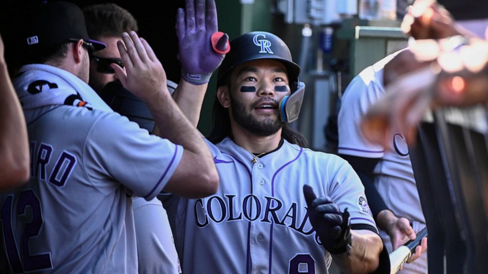 Colorado Rockies' Connor Joe (9) celebrates in the dugout after hitting a home run against the Chicago Cubs during the second inning of a baseball game, in Chicago, Sunday, Sept. 18, 2022. (AP Photo/Matt Marton)