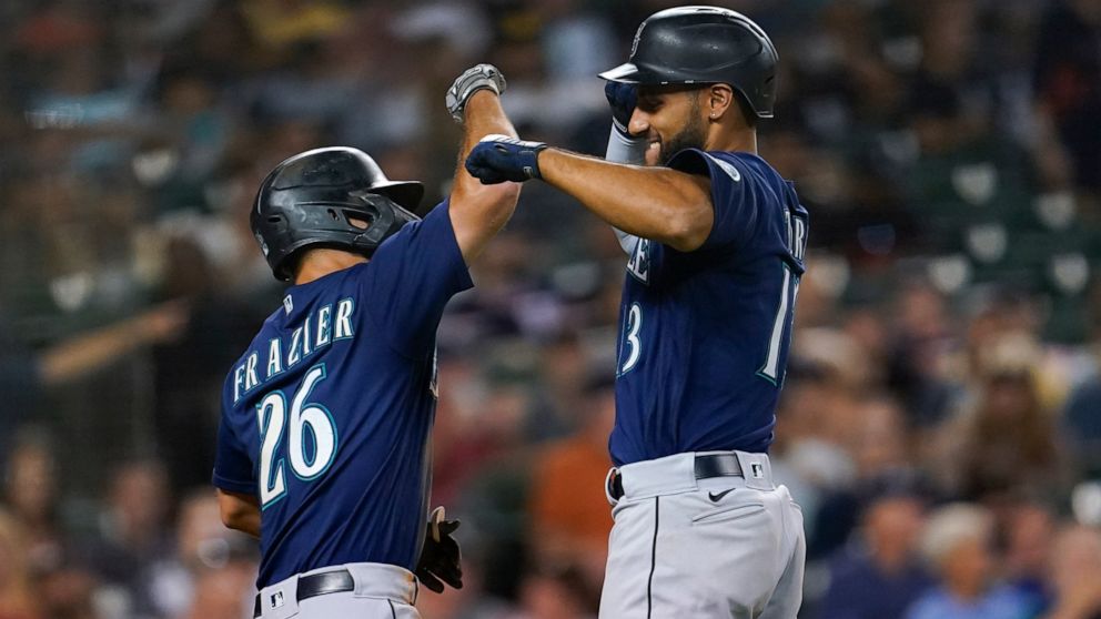 Seattle Mariners' Abraham Toro, right, celebrates his two-run home run with Adam Frazier (26) in the seventh inning of a baseball game against the Detroit Tigers in Detroit, Wednesday, Aug. 31, 2022. (AP Photo/Paul Sancya)