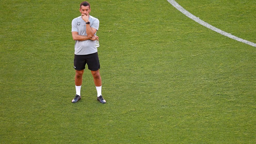 Rangers' head coach Giovanni van Bronckhorst stands during a training session at the Ramon Sanchez-Pizjuan Stadium in Seville, Spain, Tuesday, May 17, 2022. Eintracht Frankfurt and Glasgow Rangers are holding stadium training sessions ahead of the Eu